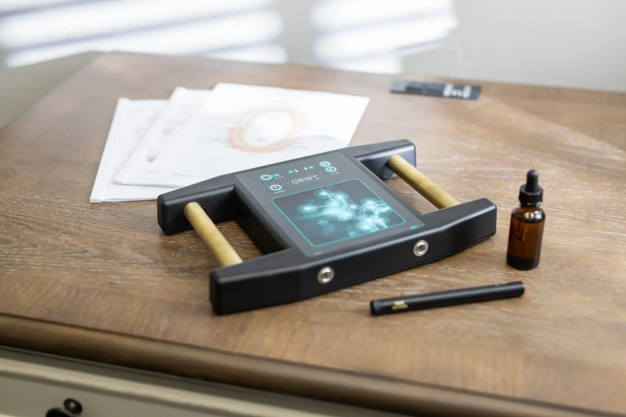 QEST4 bioenergetic scanning device on a desk with collection materials